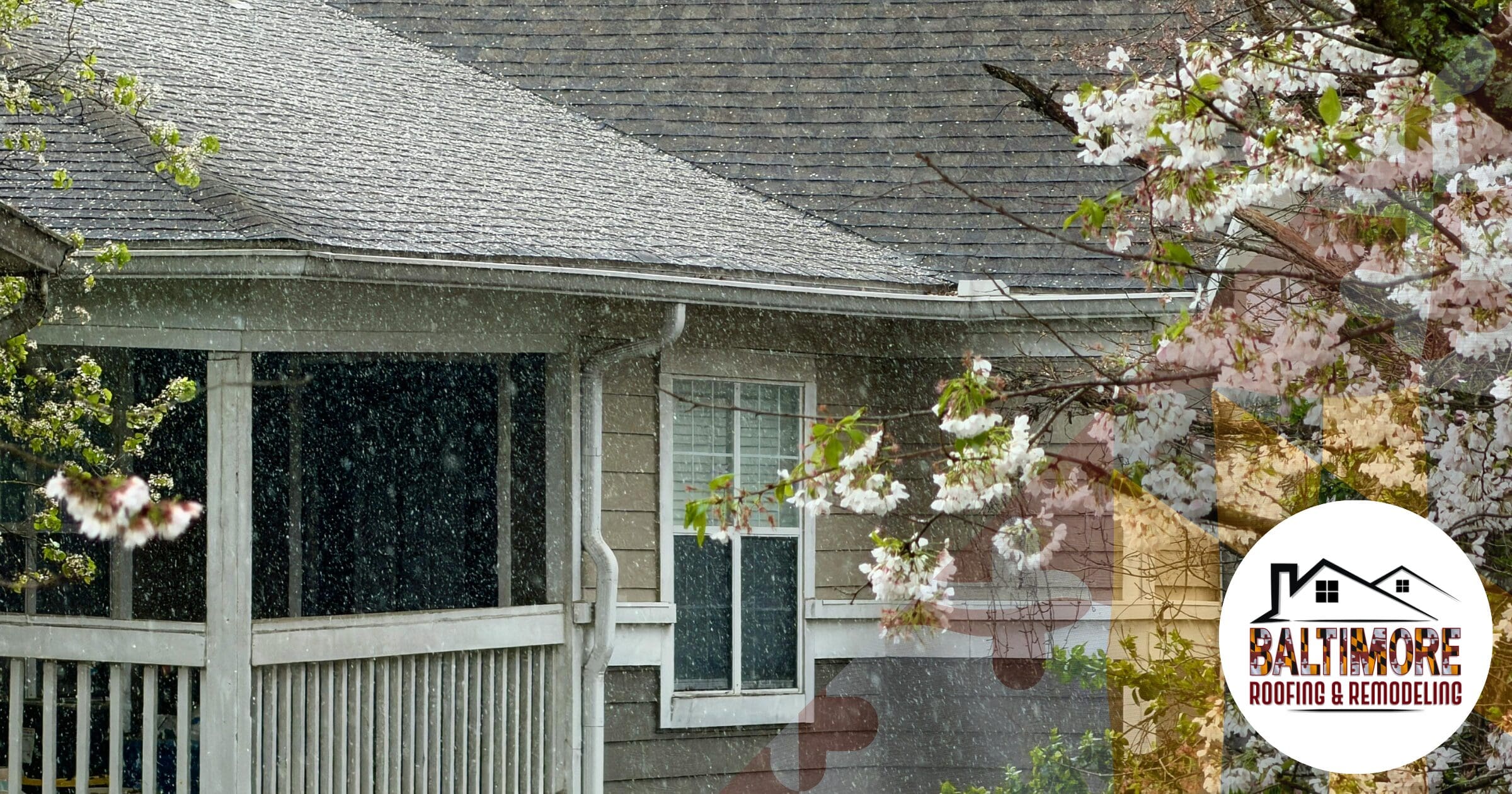 A residential home in Maryland during a steady spring rain with cherry blossoms in the foreground. This "slow soak" weather pattern creates an urgent need for the spring roof leak detection Maryland homeowners require to identify hidden moisture intrusion before structural rot begins. Features the Baltimore Roofing & Remodeling logo.