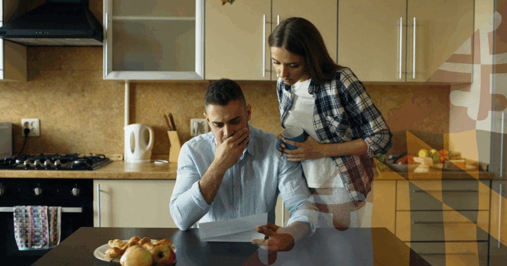 A concerned homeowner couple sitting in their kitchen, anxiously reading a sudden policy cancellation letter. This emotional stress frequently occurs when an insurance company forcing roof replacement leaves Maryland families scrambling to secure funding before a strict 30-day deadline. A faint Maryland flag pattern is overlaid on the right.