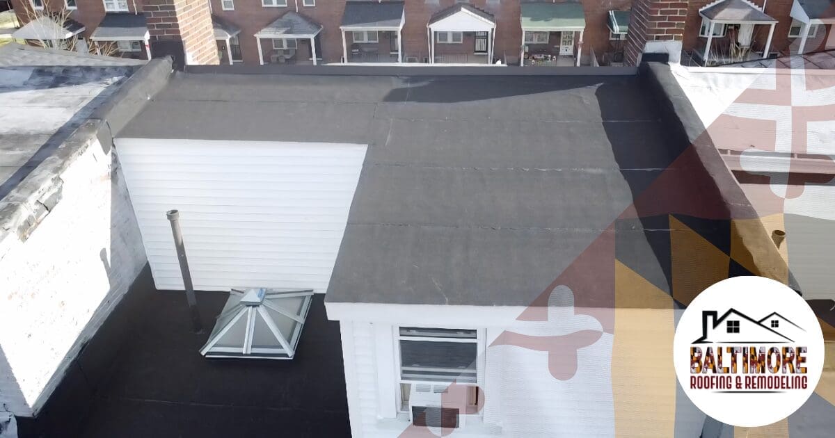 An aerial inspection view of a historic residential rowhome featuring a newly installed black EPDM rubber membrane. To permanently prevent flat roof ponding water in Baltimore, our local crews install custom tapered insulation to physically force rainwater directly toward the rear scuppers. Features the Baltimore Roofing & Remodeling logo.