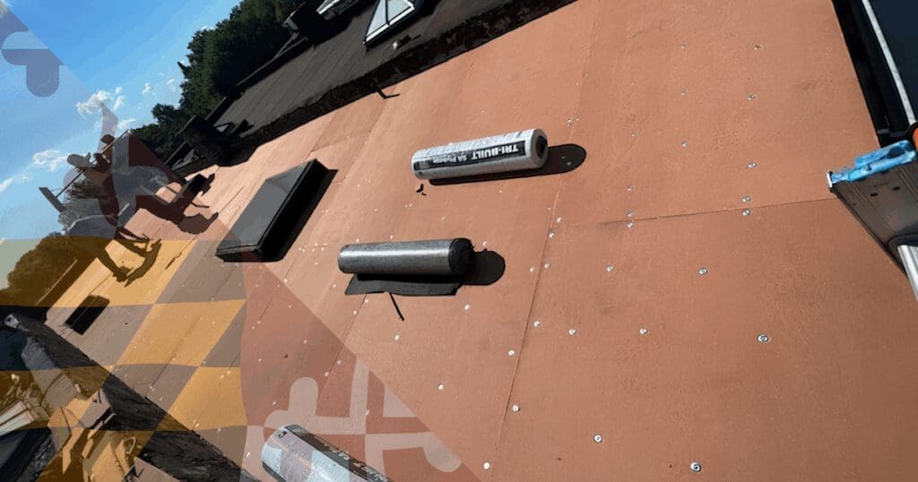 A specialized crew installing high-grade underlayment on a flat roof system, showcasing the precise structural protection required to defend historic Baltimore City architecture against severe summer temperatures.