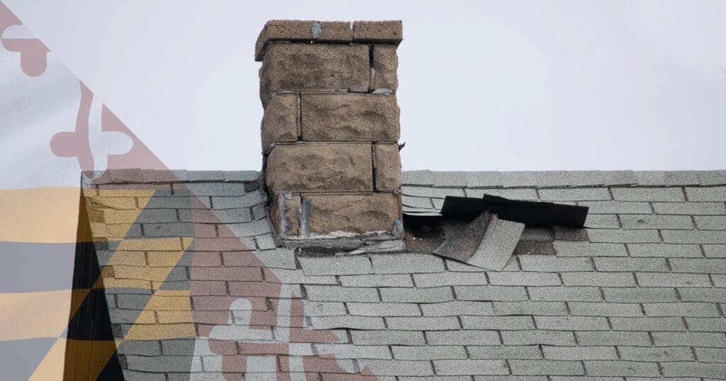 Close-up of torn and wind-damaged asphalt shingles exposing the roof deck near a stone chimney, demonstrating the exact structural vulnerabilities that storm chaser roofers Maryland communities face will use to push high-pressure contracts.