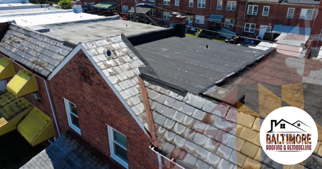 Aerial view of a historic Baltimore brick rowhome featuring a low-slope roof membrane susceptible to structural joist deflection if drainage fails.