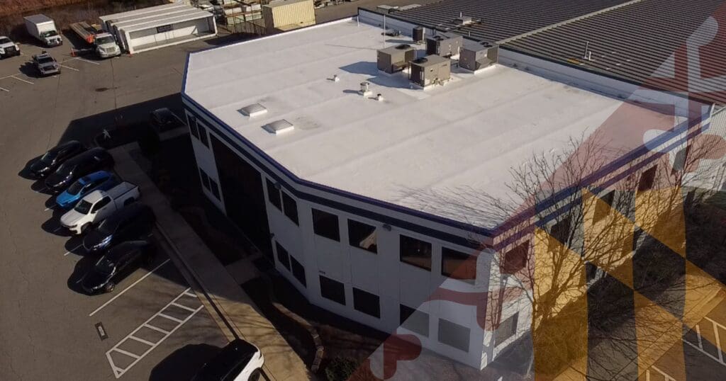 Aerial drone perspective of a large commercial building utilizing a white TPO flat roof membrane engineered with tapered insulation for optimal zero-pitch drainage.